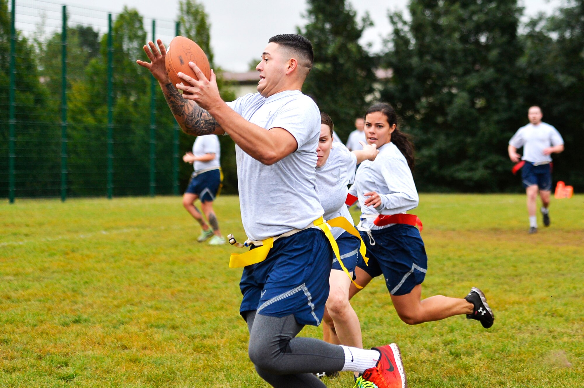 U.S. Airmen assigned to the 86th Airlift Wing play flag football on Ramstein Air Base, Germany, Sept. 6, 2017. Airmen from all over the wing competed in the annual Commander’s Challenge resiliency day. (U.S. Air Force photo by Airman 1st Class Joshua Magbanua)