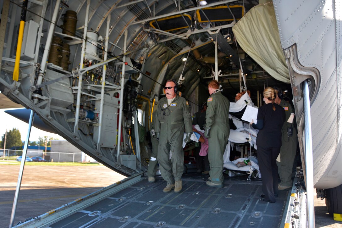 Lt. Col. Scronce looks out the back of a parked C-130 Hercules before unloading patients.