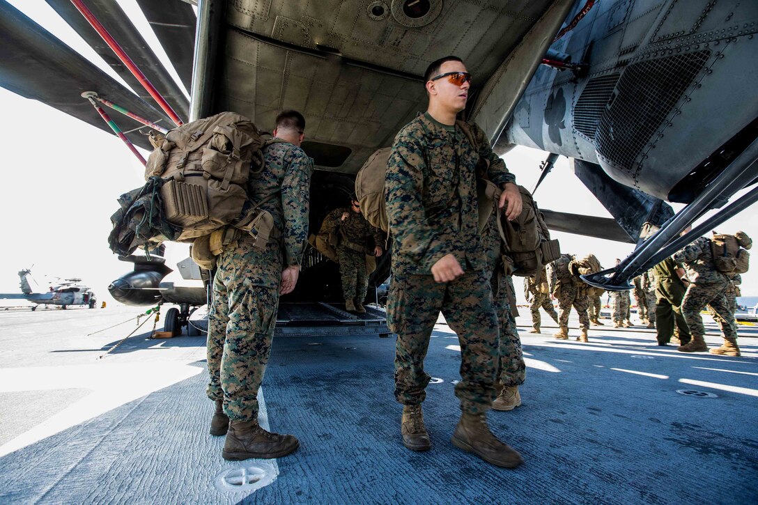 U.S. Marines with Battalion Landing Team 2nd Battalion, 6th Marine Regiment, 26th Marine Expeditionary Unit (MEU), conduct preliminary boarding procedures on a CH-53E Super Stallion helicopter and MV-22B Osprey aircraft with Marine Medium Tiltrotor Squadron 162 (Reinforced), 26th MEU, aboard the amphibious assault ship USS Kearsarge (LHD 3) in the Atlantic Ocean, Sept. 7, 2017. The preparations ensure the 26th MEU is ready to respond to any requests to bolster Northern Command's support of FEMA's assistance to federal, state and local authorities' ongoing relief efforts in the aftermath of Hurricane Irma.