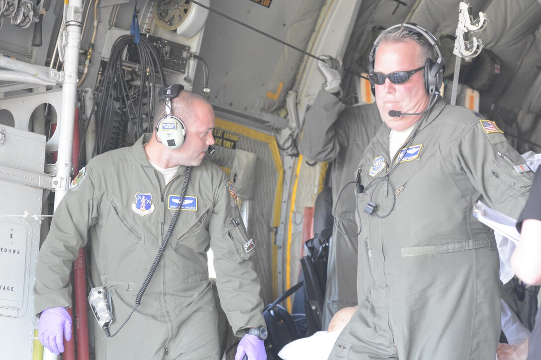 North Carolina Air National Guard Chief Master Sgt. Daniel Hallman, left, and Lt. Col. Charles Scronce transport a patient evacuated from the Lower Keys Medical Center in Key West, Fla.