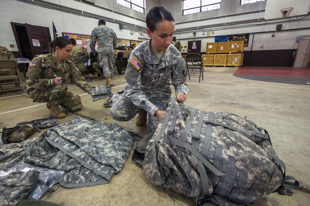 New Jersey Army National Guard Spc. Sheila Velez packs up her gear at Cape May Courthouse, N.J.