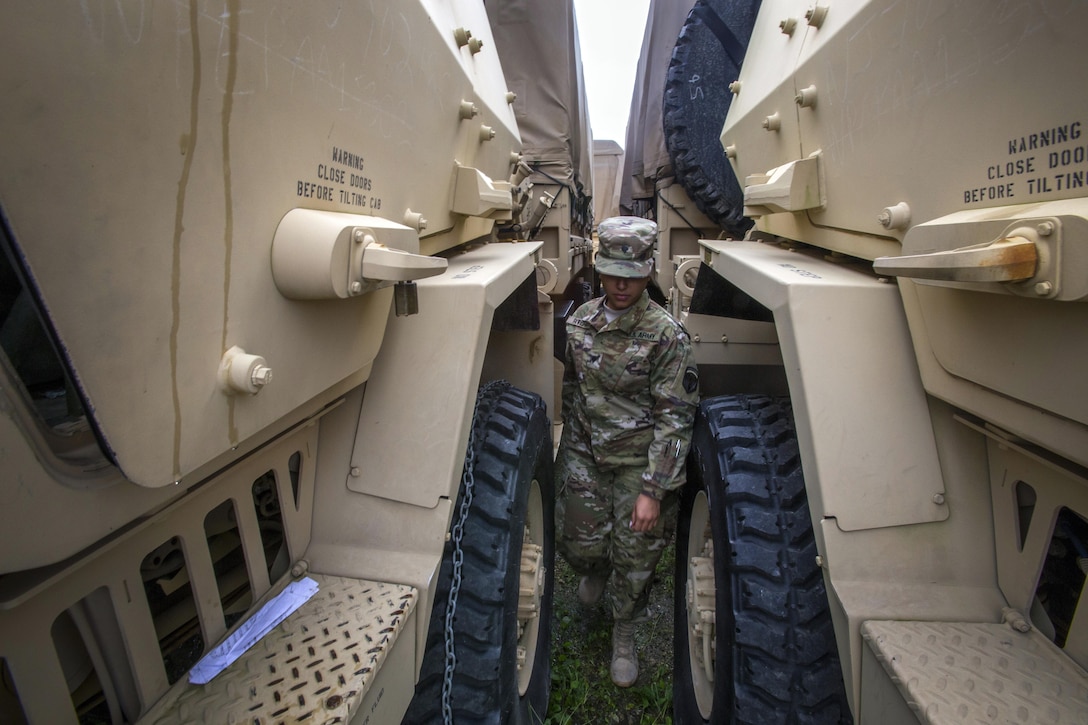 New Jersey Army National Guard Spc. Naisha Rivera performs a final inspection of a light medium tactical vehicle at Cape May Courthouse, N.J.