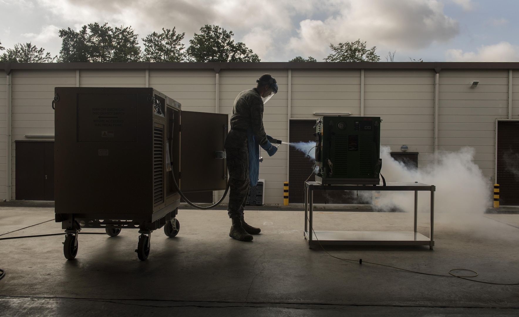 U.S. Air Force Airman 1st Class Ryan Thomas, 86th Medical Support Squadron biomedical equipment technician, holds the hose of an oxygen generator and liquefier to allow air to be pushed out so liquid oxygen is pumped into a next-generation portable therapeutic liquid oxygen on Ramstein Air Base, Germany, Sept. 17, 2017. The NTPLOX is used by aeromedical evacuation Airmen to deliver gaseous oxygen to their patients at a regulated level. (U.S. Air Force photo by Senior Airman Tryphena Mayhugh)