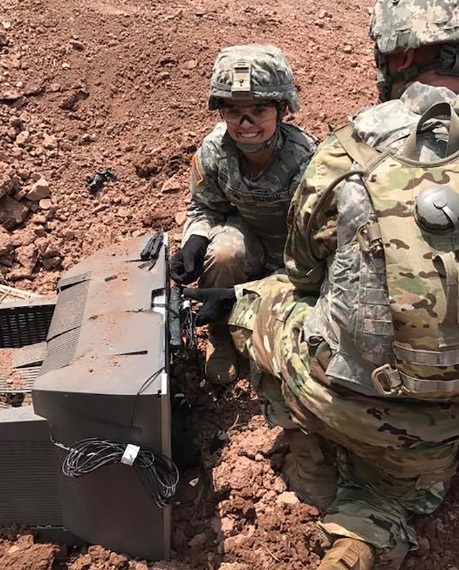 Army Sgt. Brittany Wildman sets a C4 explosive charge as part of her cavalry scout training