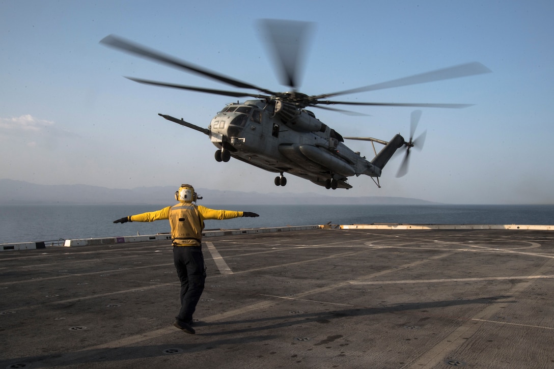 U.S. 5TH FLEET AREA OF OPERATIONS (Sept. 06, 2017) Aviation Support Equipment Technician 3rd Class Angus Moss, a native of Columbus, Indiana, assigned to the air department aboard the amphibious transport dock ship USS San Diego (LPD 22), directs an CH-53E Sea Stallion helicopter, assigned to Marine Medium Tiltrotor Squadron 161 (reinforced) on the ship’s flight deck as part of Alligator Dagger exercise. Alligator Dagger is a dedicated, unilateral combat rehearsal led by Naval Amphibious Force, Task Force 51/5th Marine Expeditionary Brigade, in which combined Navy and Marine Corps units of the America Amphibious Ready Group and embarked 15th Marine Expeditionary Unit are to practice, rehearse and exercise integrated capabilities that are available to U.S. Central Command both afloat and ashore. (U.S. Navy photo by Mass Communication Specialist 3rd Class Justin A. Schoenberger/Released)