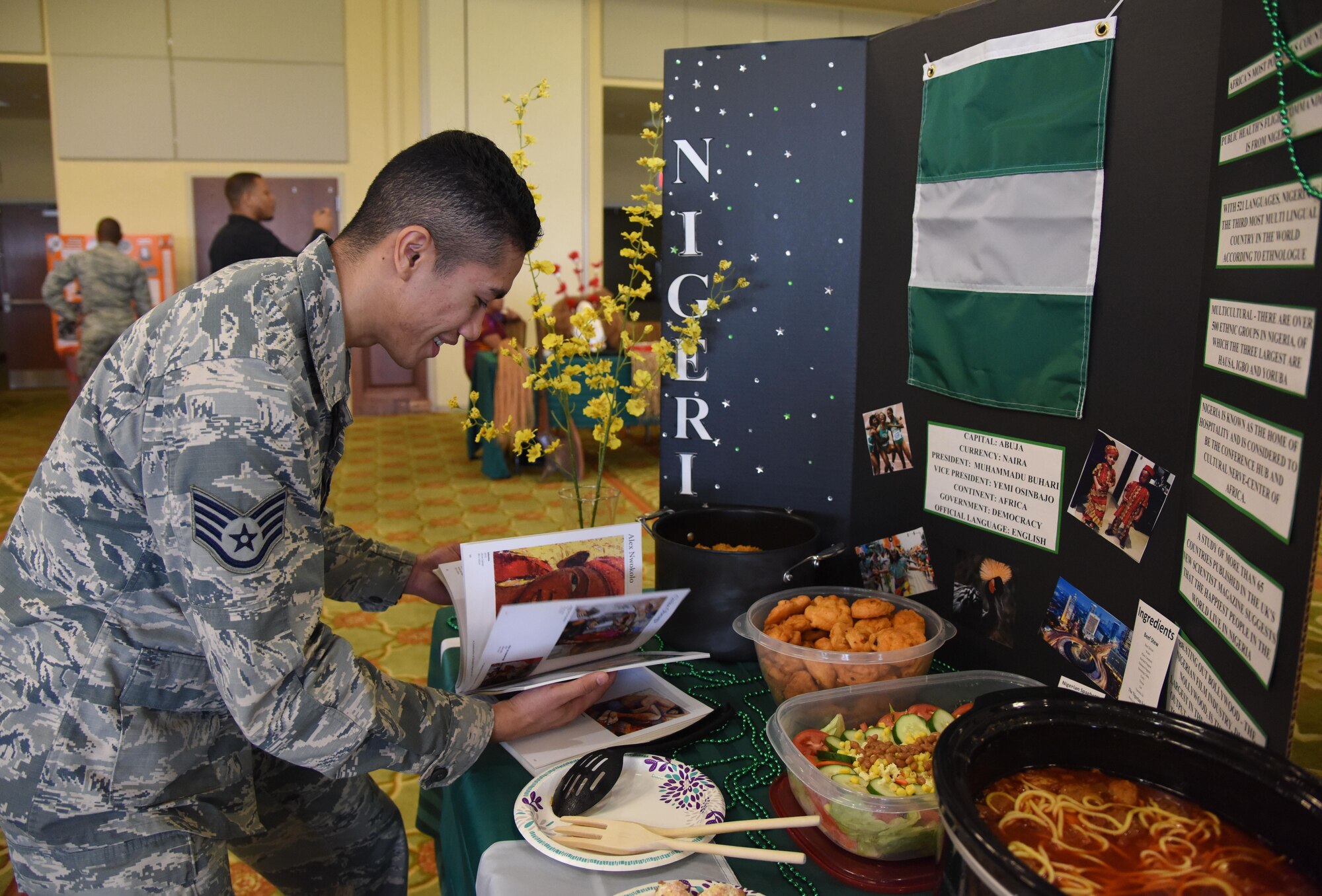 Staff Sgt. Earl Pecson, 81st Diagnostic and Therapeutics Squadron pharmacy technician, views a Nigerian artist book during Diversity Day at the Bay Breeze Event Center Sept. 6, 2017, on Keesler Air Force Base, Miss. The cultural celebration included food sampling and information booths about countries around the world and other special emphasis groups. (U.S. Air Force photo by Kemberly Groue)