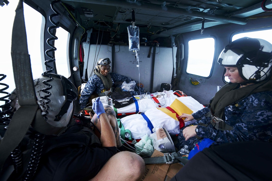 Hurricane victims are transported in a helicopter.