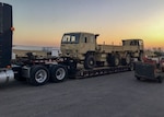 Two former military trucks, issued by DLA Disposition Services through the 1033 program to Texas law enforcement, depart the Texas Federal State Property San Antonio Office as the sun sets. The next morning the trucks were operating on the east side of Houston rescuing people from flooding caused by Hurricane Harvey.