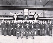 IMAGE: 8x10 negative
Group photo of 26 aviation personnel, 4 officers, 22 pilots/sailors in front of a twin engine plane