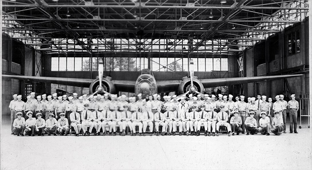 IMAGE: July 1, 1942
AVIATION HISTORY: Naval Air Detail, First Row L-* (kneeling): CPO's Greenwood, Rice, Ackeroyd,
Lackey, Karney. Seated L-R (JG) Stewart, Lt. Jenkins, Lt. (JG) Taylor, Lt. Parker, Lt. Preston, Lt.
Bosworth, Lt Comdr. Eckelmeyer, Lt Comdr. Busey, Lt. Kebbe, Lt. (JG) Koeber, Lt (JG) Roe, Lt (JG)
Wheatley, Lt (JG) Salamone, Lt (JG) Dickinson, Ensign Hanson, Lt. (JG) Fry. Kneeling L-R: CPO's
Leonard, Haas, Juth, McDaniels. Standing L-R: Lane, England, Smith, Hayes, Padgett, Sweeney,
Pollock, Roe, Atwell, York, Foley, Williams, H.C., Jenkind, Richardson, Edgell, Castro, Rant, Stoye,
Maduska, Jourdan, Campbell, Ostgard, Pelaney, Grow, Lingren, Smith, Hall, Dye, Hudson, Standley,
Frazier, Mcginty, Brown, Dubray, Barnes, Walker, Neukam, Minkle R., Colman, Hocking, Lactrup,
McDonald, Flowers, Collins, Mr. McElroy, Williams, H., Mr. Middlebrook, Warren, Mr. Talley, Osborne,
Mr. <ruskall, Rawson, Spencer, Painter