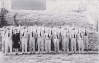 IMAGE:10/7/1944
[Lt. Philipchuk returned to Dahlgren and worked in TE until he died young CA 1970. Lt. Hersey might be Dr. Alan Hersey, K Computer leader. Lt J.J. Glancy - became engineer and community leader.] [W.W. Meyers stayed in Dahlgren and became a division ehad in the new G department "wes"] In front of storage mound, Armor Department Officers, Front row L-R: Lt. (JG) C. Philipchuk, USNR: Ens. H.I. Olson, USNR: Lt. (JG) L.W. Mahinney, USNR: Lt (JG) Burstein, USNR: Comdr. G.K. Williams, USN: Comdr. H.S. Harnly, USN: Comdr. G.T. Atkins, USN: Lt. J.E. Sandberg, USNR: Lt. (JG) H.E. Brehm, USNR: Lt (JG) R.R. Hershey, USNR: Back Row L-R: Lt. H.R. Pflug, USNR: Lt. G.A. Rauch, USNR, Lt. D.E. Thomas, USNR: Lt. P.A. Krentel, USNR: Lt. M.R. Herman. USNR, Lt (JG) F.G. Brune, USNR: Lt. J.J. Clancy, USNR: Ens. S.S> Cross, USNR: Lt. (JG) W.W. Meyers, USNR: Lt R.C. Smith, USNR: Ens. C.H. Waldhauer, USNR; Not Present in Photo: Lt T.A. Priger, USNR: Lt. (JG) M.M. Sirota, USNR: and Ch. Gunner Glen Frazier, USN.