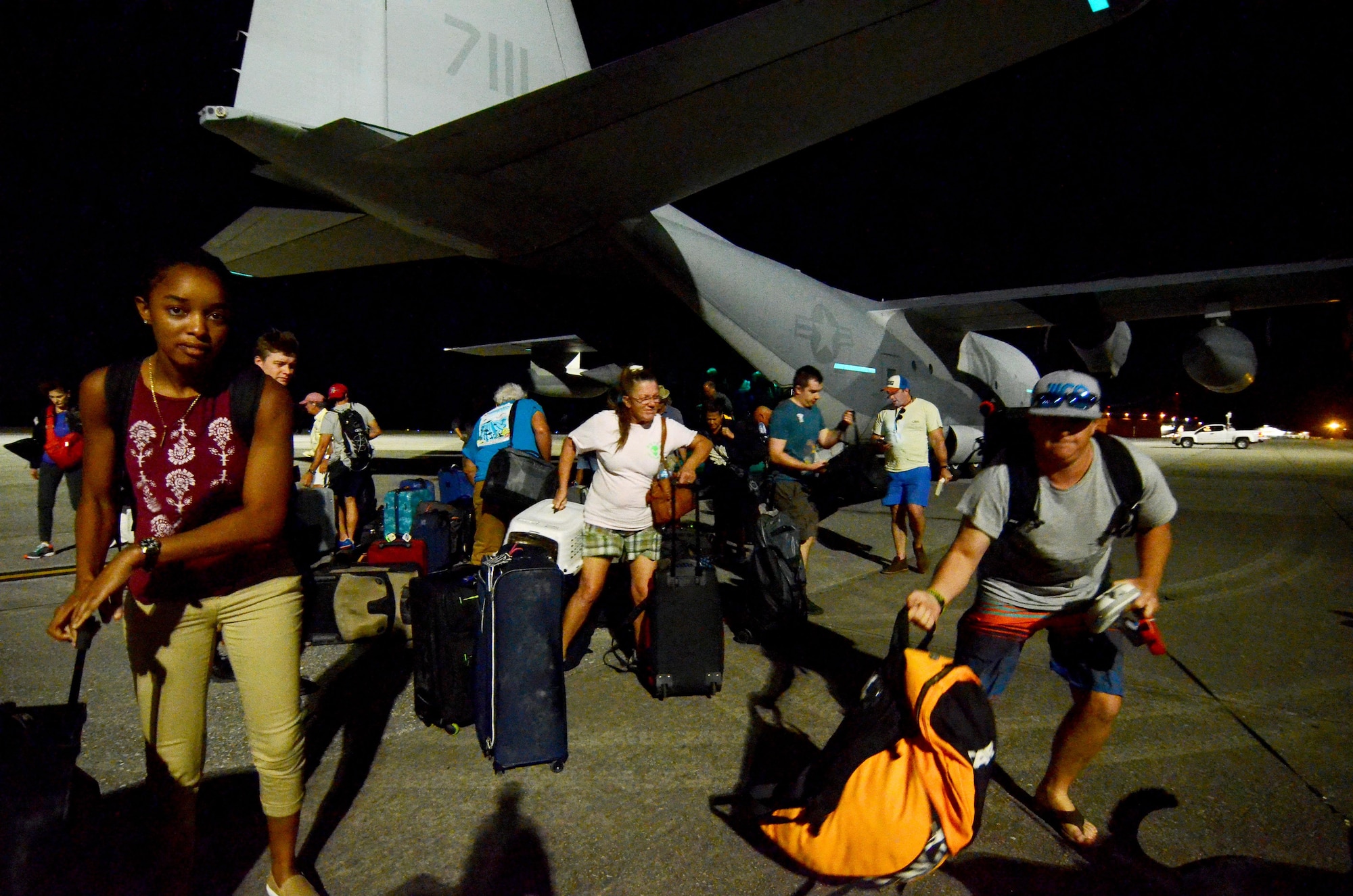 Evacuees retrieve their luggage from the flightline at Dobbins Air Reserve Base, Ga. Sept. 6, 2017. The aircraft carried civilian and contract Department of Defense personnel who were evacuated from the Caribbean in anticipation of Hurricane Irma. (U.S. Air Force photo/Don Peek)