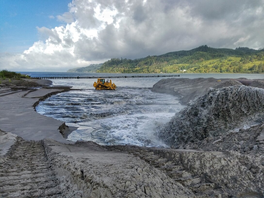 Material dredged from the Lower Columbia River Federal Navigation Channel is graded following shoreline placement to assist in habitat creation.