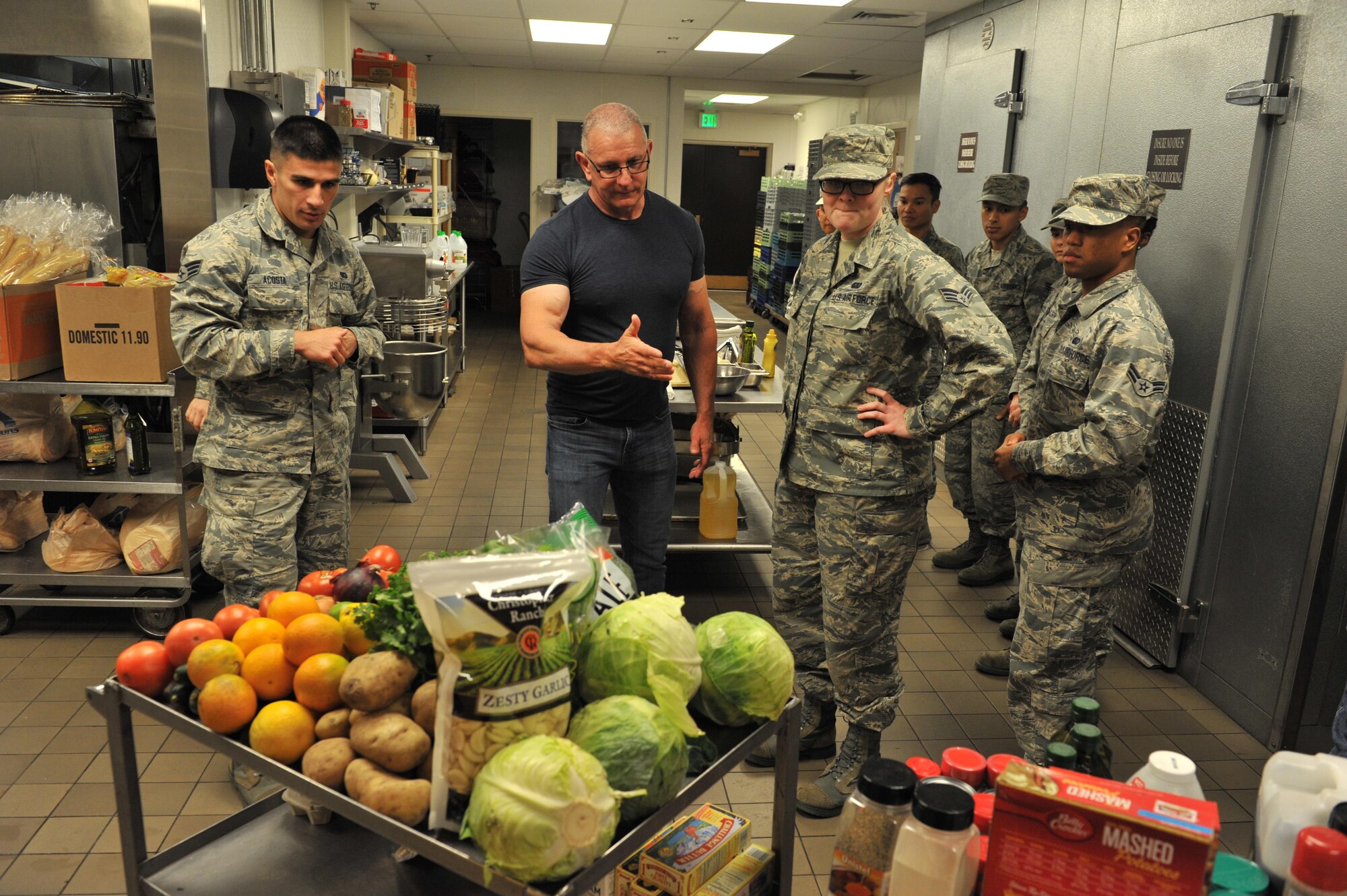 Celebrity Chef Robert Irvine shows missile field chefs from Malmstrom, Minot and F.E. Warren how to use fresh ingredients to enhance flavor in their dishes Sept. 7, 2017, at Malmstrom Air Force Base, Mont.  Chef Irvine spent time mentoring and training missile field chefs during his visit.  (U.S. Air Force photo/John Turner)