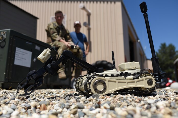 Senior Airman Jared Basham, 9th Civil Engineer Squadron ordnance disposal technician, controls a Micro Tactical Ground Robot to search for a buried training explosive device at Beale Air Force Base, California, July 28, 2017. EOD Airmen use remote controlled robots to neutralize explosives while at a safe distance.