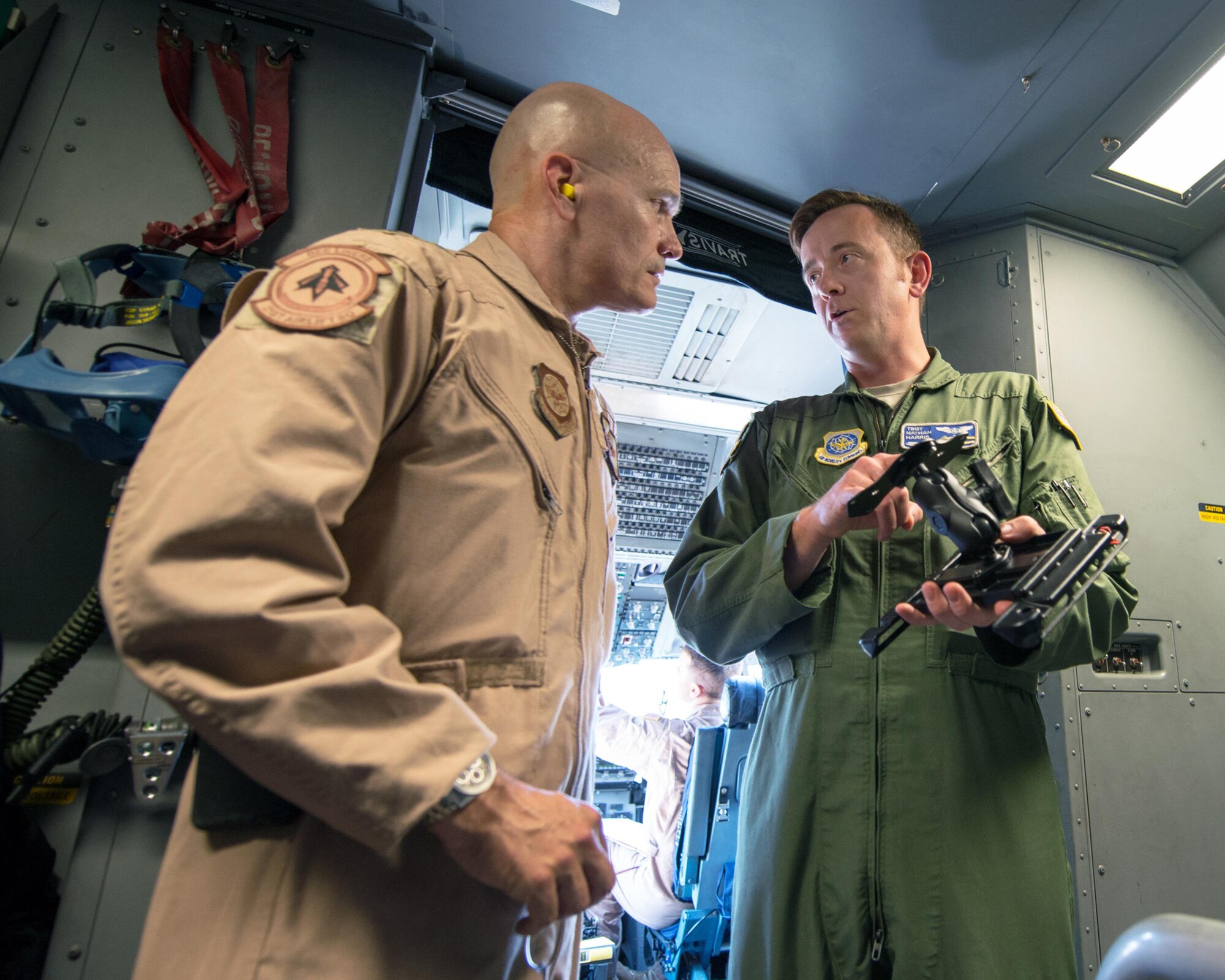 U.S. Air Force Gen. Carlton D. Everhart II, Air Mobility Command commander, Scott Air Force Base, Ill., talks with Tech. Sgt. Nathaniel Harris, 60th Operations Group, about a newly developed mounted electronic flight bag holder for the C-17 Globemaster III at Travis Air Force Base, Calif., August 12, 2017. Under the auspice of Phoenix Spark, the 60th OG is working with the 60th Maintenance Group to design and approve the mount for all three aircraft assigned to the 60th Air Mobility Wing. This was the first time any USAF aircrew had utilized the new EFB mount. Phoenix Spark is a program chartered by Everhart to empower AMC Airmen to innovate in finding ways to modernize the Air Force. (U.S. Air Force photo by Louis Briscese)