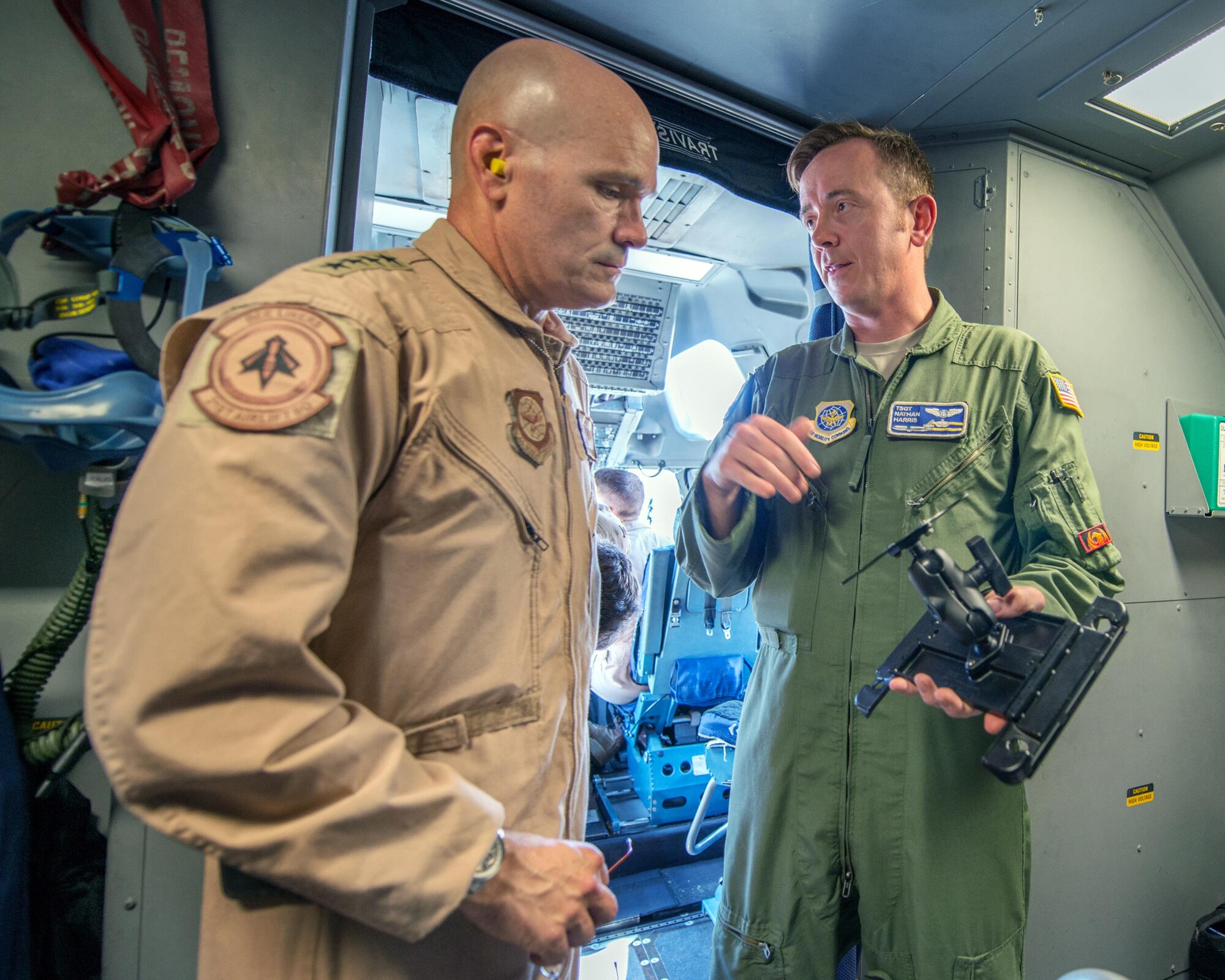 U.S. Air Force Gen. Carlton D. Everhart II, Air Mobility Command commander, Scott Air Force Base, Ill., talks with Tech. Sgt. Nathaniel Harris, 60th Operations Group, about a newly developed mounted electronic flight bag holder for the C-17 Globemaster III at Travis Air Force Base, Calif., August 12, 2017. Under the auspice of Phoenix Spark, the 60th OG is working with the 60th Maintenance Group to design and approve the mount for all three aircraft assigned to the 60th Air Mobility Wing. This was the first time any USAF aircrew had utilized the new EFB mount. Phoenix Spark is a program chartered by Everhart to empower AMC Airmen to innovate in finding ways to modernize the Air Force. (U.S. Air Force photo by Louis Briscese)
