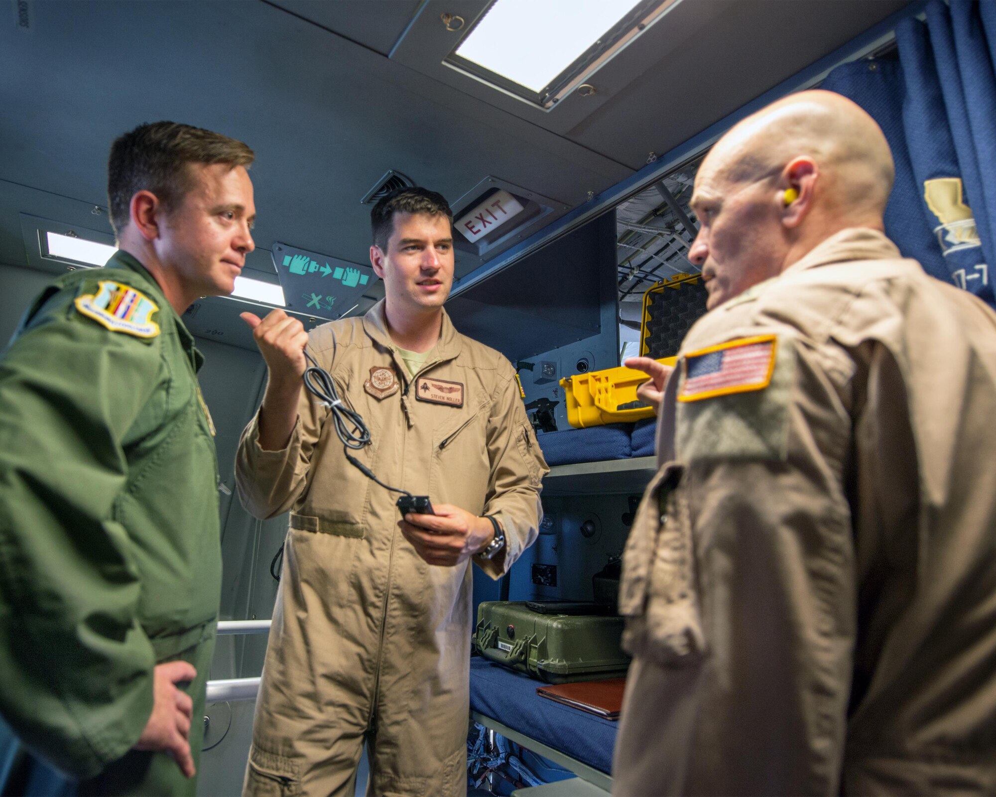 U.S. Air Force Gen. Carlton D. Everhart II, Air Mobility Command commander, Scott Air Force Base, Ill., talks with Tech. Sgt. Nathaniel Harris, 60th Operations Group, and Capt. Steven Noller, 21st Airlift Squadron pilot, about a newly developed mounted electronic flight bag holder for the C-17 Globemaster III at Travis Air Force Base, Calif., August 12, 2017. Under the auspice of Phoenix Spark, the 60th OG is working with the 60th Maintenance Group to design and approve the mount for all three aircraft assigned to the 60th Air Mobility Wing. This was the first time aircrew employed the EFB mount, which utilizes the old approach plate holder in the flight desk. Phoenix Spark is a program chartered by Everhart and empowers Airmen of all levels to innovate rapidly while navigating the administrative hurdles of compliance. (U.S. Air Force photo by Louis Briscese)