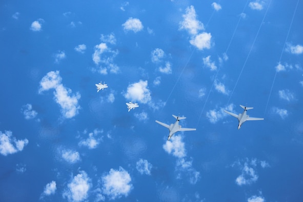 Two U.S. Air Force B-1B Lancers fly a bilateral mission with two Koku Jieitai (Japan Air Self-Defense Force) F-15s in the vicinity of the East China Sea, Sept. 9, 2017. Following the end of the operation, one B-1B split off to Misawa Air Base, Japan, to be a static display for the Misawa Air Festival, while the other B-1B returned to Andersen Air Force Base, Guam. The purpose of bilateral training is to foster increased interoperability between Japan and U.S. aircraft. Participating in bilateral training enables the operational units to improve their combined capabilities and tactical skills, while also building bilateral confidence and strong working relationships. (Courtesy Photo)