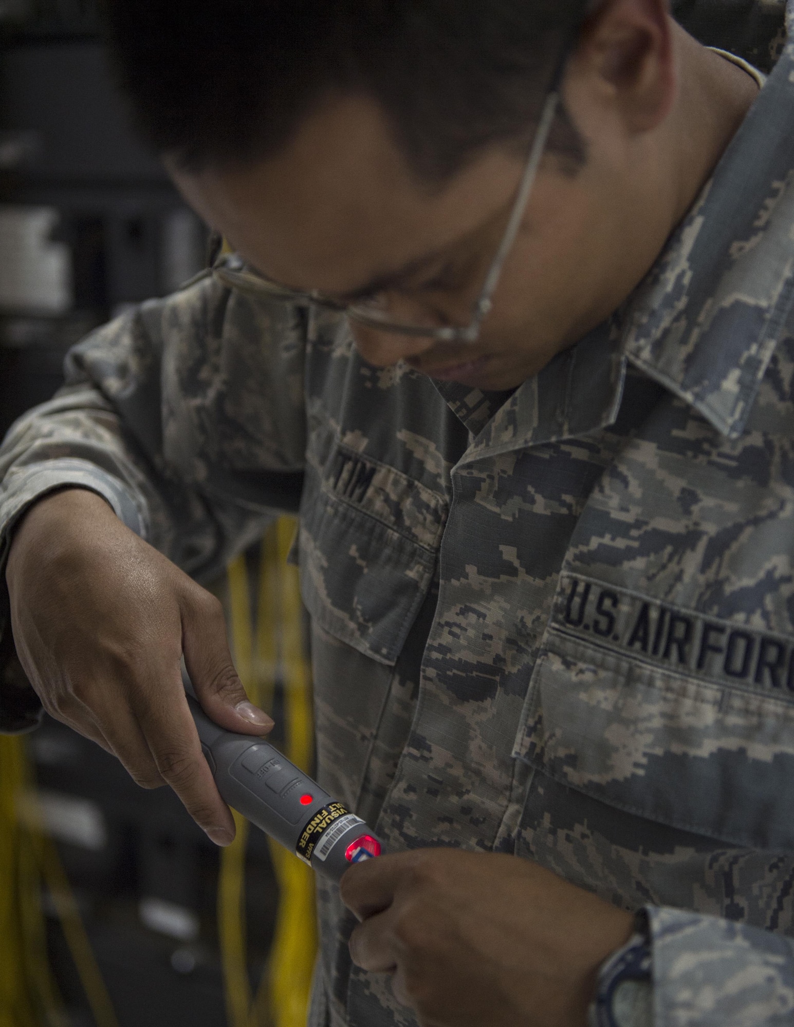 U.S. Air Force Senior Airman Monorom Tim, a network management technician with the 379th Expeditionary Communication Squadron, uses a visual fault finder to test the continuity of the fiber links at Al Udeid Air Base, Qatar, July 14, 2017.