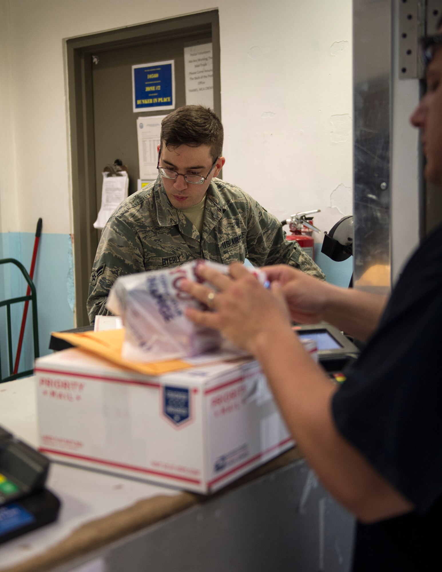 U.S. Air Force Airman 1st Class Stephen Byerly, a finance clerk with the 379th Expeditionary Communication Squadron, enters customer information into a computer at Al Udeid Air Base, Qatar, July 14, 2017.