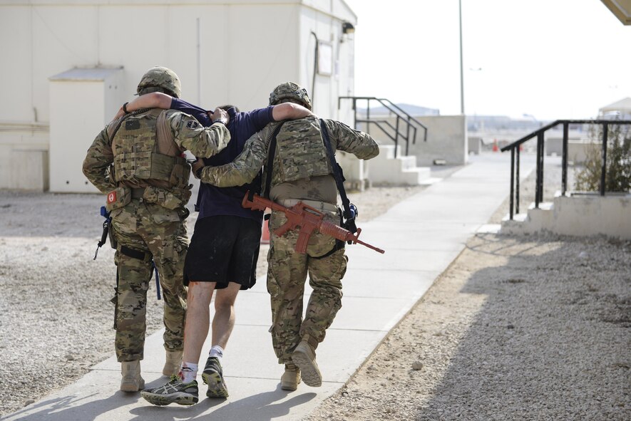 U.S. Air Force Security Forces members assist a simulated casualty to safety during an active shooter exercise conducted at Al Udeid Air Base, Qatar, Aug. 31, 2017.