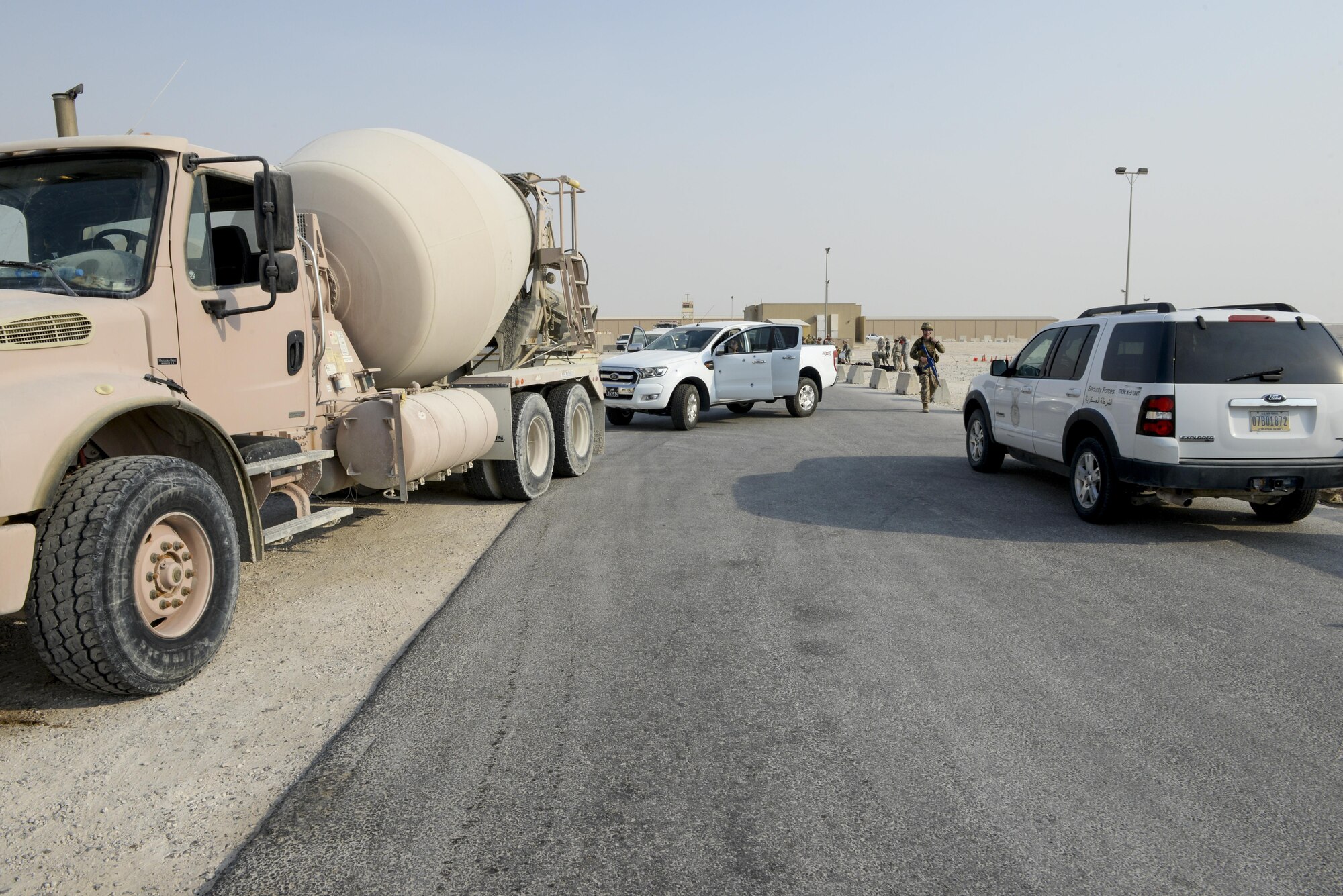 A U.S. Air Force security forces member, assigned to the 379th Expeditionary Security Forces Squadron, walks through a simulated crime scene toward a security forces vehicle during an active shooter exercise conducted at Al Udeid Air Base, Qatar, Aug. 31, 2017.