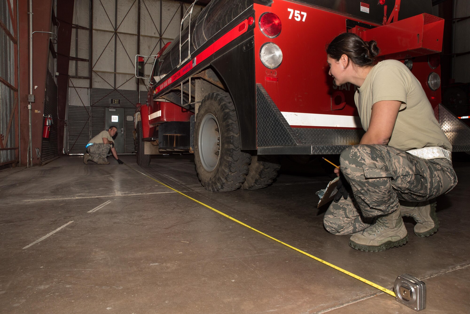 Master Sgt. Catie Lammers and Senior Airman Benjamin Gustin, air transportation specialists with the 27th Aerial Port on Minneapolis-St. Paul Air Reserve Station, Minn. annotate measurements for multiple vehicles being shipped to Nicaragua at Volk Field, Wis. Sep. 5, 2017. Weights and dimensions of the vehicles assist in planning the load for optimal placement within the aircraft.   (U.S. Air Force photo by Master Sgt. Eric Amidon/ Released)