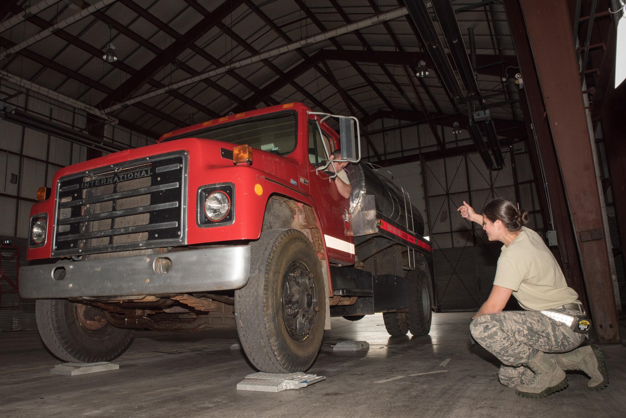 Master Sgt. Catie Lammers and Senior Airman Benjamin Gustin, air transportation specialists with the 27th Aerial Port on Minneapolis-St. Paul Air Reserve Station, Minn. use portable scales to annotate the weight of a vehicles being shipped to Nicaragua at Volk Field, Wis. Sep. 5, 2017. Accurate weights are necessary to prevent exceeding the weight restrictions of the aircraft .   (U.S. Air Force photo by Master Sgt. Eric Amidon/ Released)