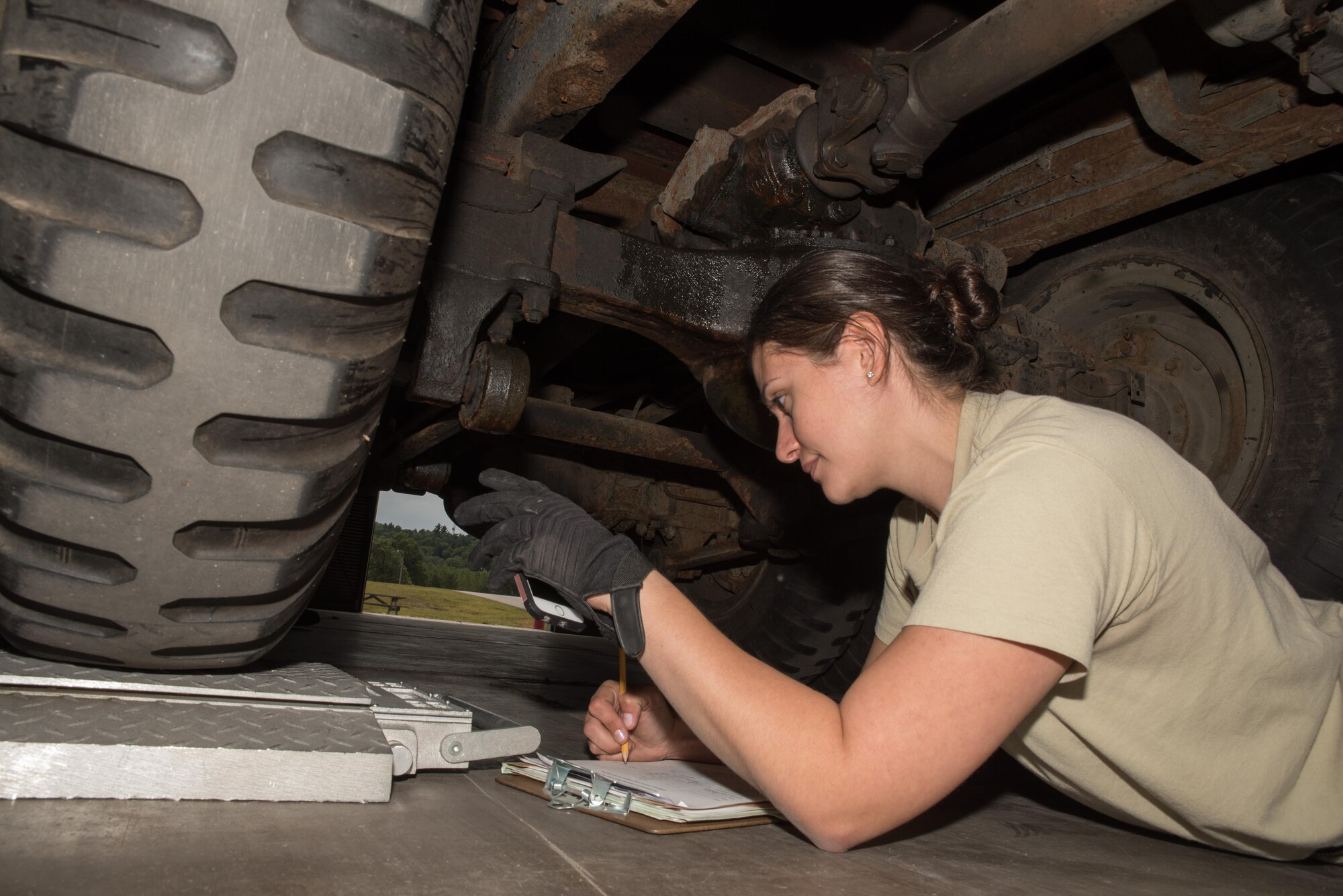 Master Sgt. Catie Lammers, an air transportation specialist with the 27th Aerial Port on Minneapolis-St. Paul Air Reserve Station, Minn. records the weight of the inner wheel on a vehicle being shipped to Nicaragua at Volk Field, Wis. Sep. 5, 2017. Recording the weights of all tires coming in contact with the aircraft floor helps determine the vehicles center-of-balance which must be determined before the weight and balance of a loaded aircraft can be computed.   (U.S. Air Force photo by Master Sgt. Eric Amidon/ Released)