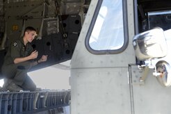 Staff Sgt. Dungan Farver, 16th Airlift Squadron loadmaster, directs a k-loader as it backs up to a C-17 Globemaster III Sept. 8, 2017.