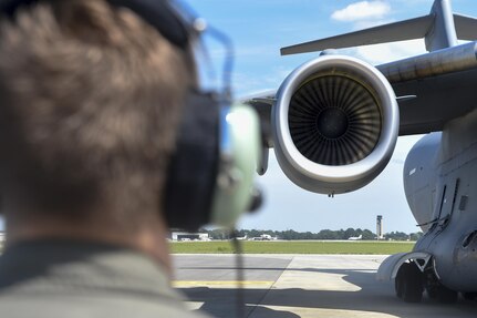 Staff Sgt. Drew Gayhart, 16th Airlift Squadron loadmaster, checks the engines of a C-17 Globemaster III as it prepares to depart Joint Base Charleston in preparation for Hurricane Irma Sept. 8, 2017.