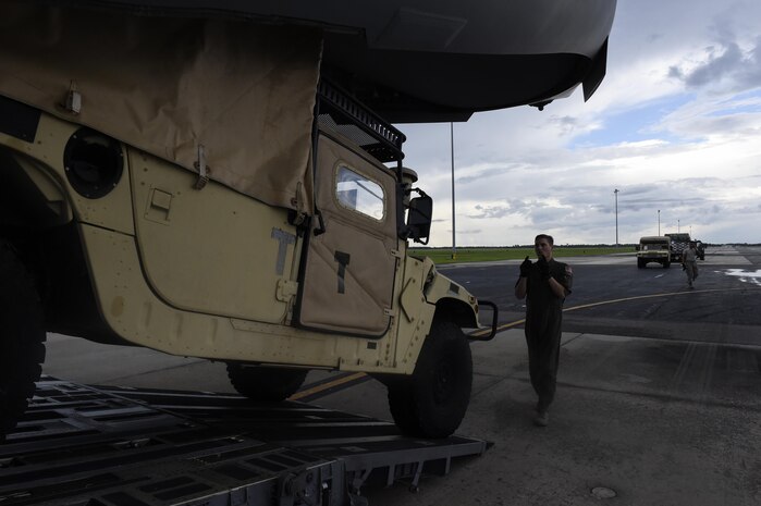Staff Sgt. Dungan Farver, 16th Airlift Squadron loadmaster, directs a humvee as it backs up to a C-17 Globemaster III at MacDill Air Force Base, Florida, Sept. 8, 2017.