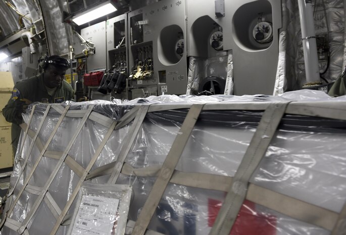 Staff Sgt. Tyle Scott, 16th Airlift Squadron crew chief, moves a pallet of medical supplies after landing at Scott Air Force Base, Illinois, Sept. 8, 2017.