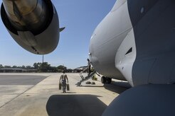 A crew member walks along a C-17 Globemaster III before departing from Joint Base Charleston, South Carolina, in preparation for Hurricane Irma, Sept. 8, 2017.