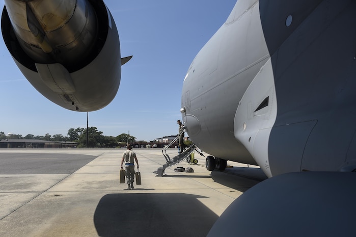 A crew member walks along a C-17 Globemaster III before departing from Joint Base Charleston, South Carolina, in preparation for Hurricane Irma, Sept. 8, 2017.