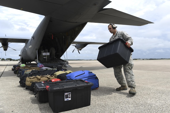 Staff Sgt. Kyle Chambasian, 19th Aircraft Maintenance Squadron flying crew chief, unloads medical equipment from a C-130J assigned to the 41st Airlift Squadron, Sept. 9, 2017, at Orlando International Airport, Fla. The 41st AS delivered medical personnel from state Disaster Medical Assistance Teams and U.S. Public Health Rapid Deployment Force personnel to Florida to prepare for Hurricane Irma relief efforts. Response teams brought triage kits, pharmaceuticals and basic medical supplies for relief efforts. (U.S. Air Force photo by Senior Airman Mercedes Taylor)