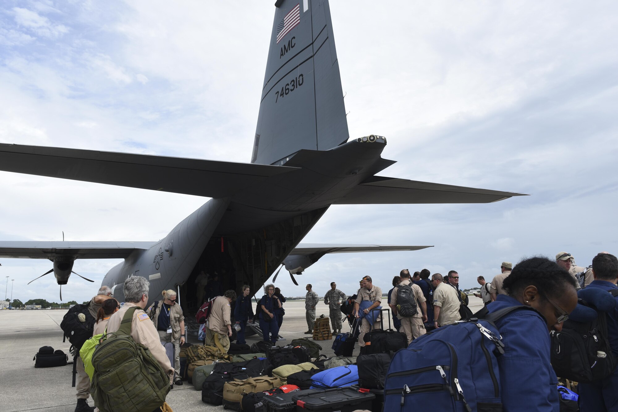 State Disaster Medical Assistance Teams and U.S. Public Health Rapid Deployment Force personnel gather their luggage and medical supplies after arriving in a C-130J assigned to the 41st Airlift Squadron, to Orlando, Fla., Sept. 9, 2017. The 41st Airlift Squadron, stationed at Little Rock Air Force Base, Ark., delivered medical response teams to Florida to prepare for relief efforts after Hurricane Irma. (U.S. Air Force photo by Senior Airman Mercedes Taylor)