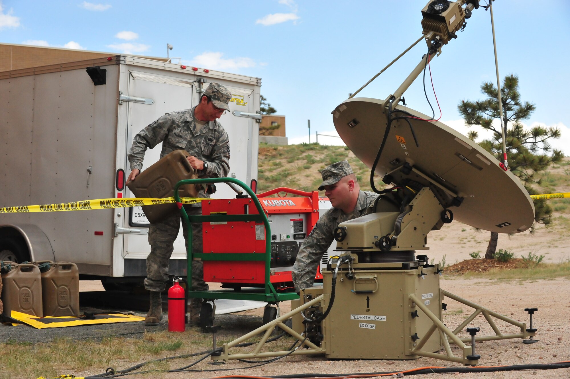 Two Airmen operate communications equipment