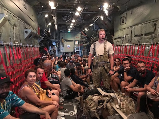 Members of the New York Air National Guard's 106th Rescue Wing assist in the evacuation of stranded American citizens from Princess Juliana International Airport in St. Maarten.