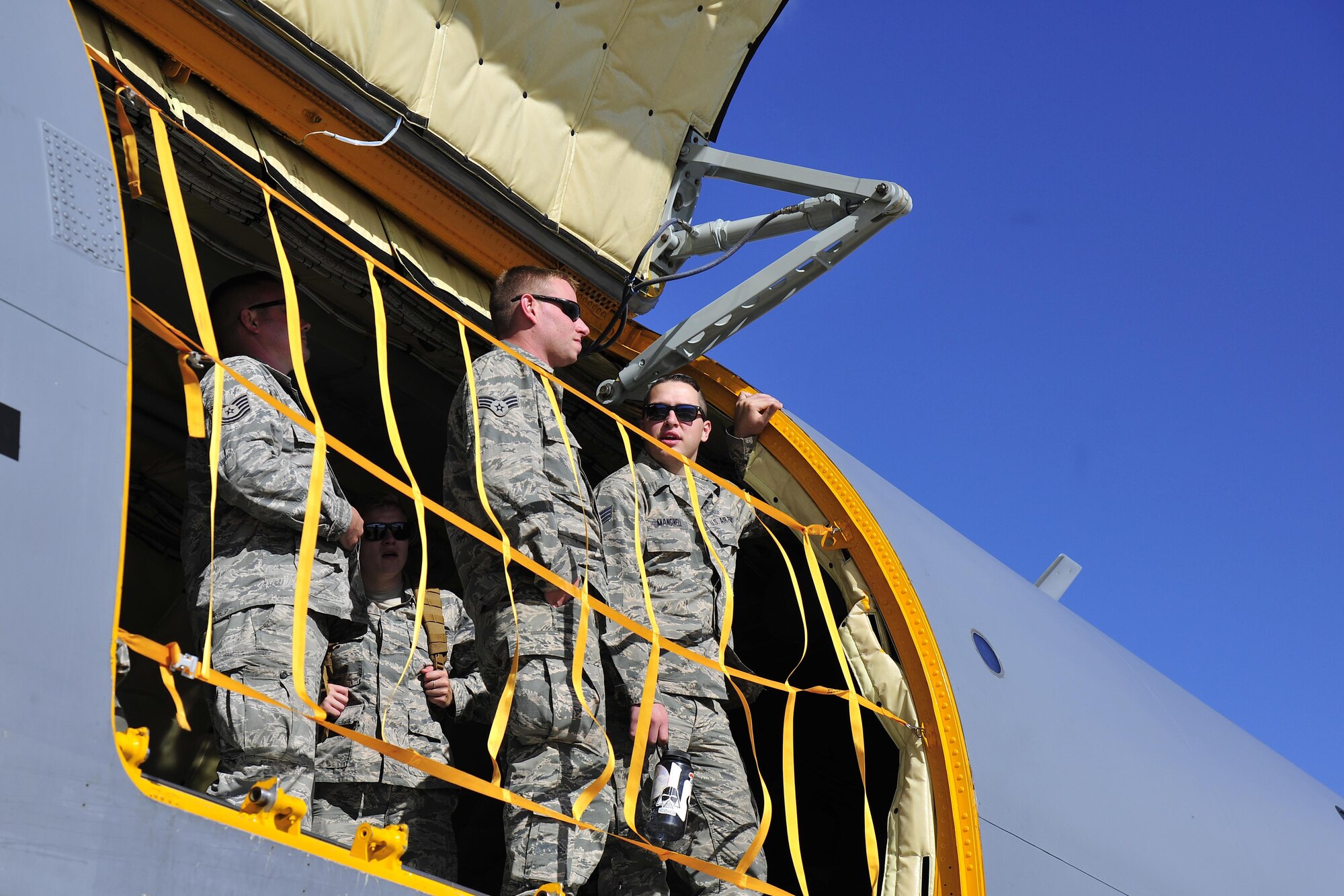 Members of the 113th Wing, D.C. Air National Guard, look out the door of a 459th Air Refueling Wing KC-135 Stratotanker at Joint Base Andrews, Maryland, Sept. 9, 2017.  Aircrews from the 459th ARW picked up the guardsmen at Tyndall Air Force Base, Florida, earlier in the day due to the threat of Hurricane Irma. (U.S. Air Force photo by Tech. Sgt. Brent A. Skeen)