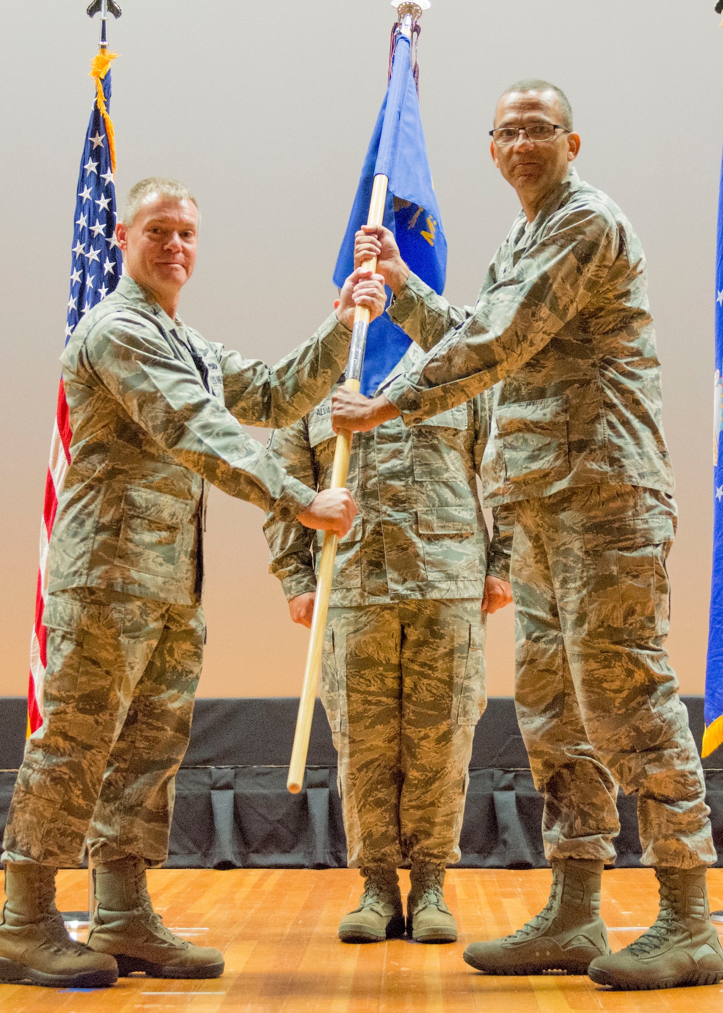 Image of Col. Craig Peters passing a unit flag to Col. Arthur Rodi.