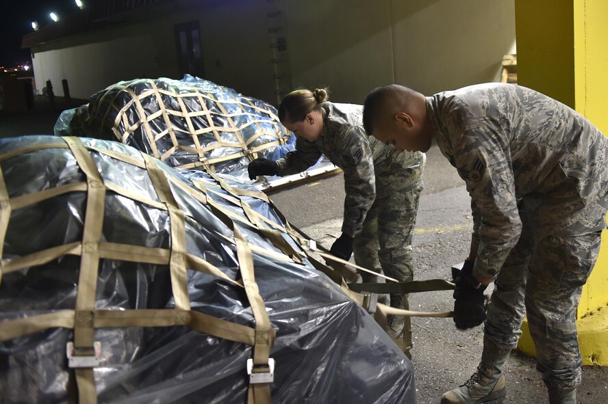 Senior Airmen Austin Rozelle-Murphy and Benjamin Morris, both 821st Contingency Response Support Squadron aerial porters, secure cargo for aerial shipment, Sept. 9, 2017, at Travis Air Force Base, Calif. Two contingency response teams from the 821st Contingency Response Group at Travis AFB, and a third from the 621st CRGat Joint Base McGuire-Dix-Lakehurst, N.J., prepositioned at Scott AFB, Ill., to await forward deployment to support ongoing relief efforts in the wake of Hurricane Irma. (U.S. Air Force photo by Tech. Sgt. Liliana Moreno)