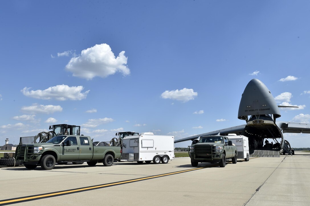 Cargo is offloaded from a C-5M Super Galaxy, September 9, 2017, at Scott Air Force Base, Ill. Two contingency response teams from the 821st Contingency Response Group at Travis Airforce Base, Calif., and a third from the 621st Contingency Response Group at Joint Base McGuire-Dix-Lakehurst, N.J. prepositioned at Scott AFB, to await forward deployment to support ongoing relief efforts in the wake of Hurricane Irma.  (U.S. Air Force photo by Tech. Sgt. Liliana Moreno/Released)