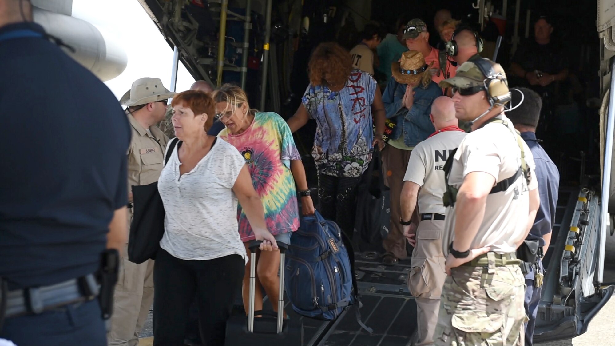 Rescued U.S. citizens deplane the Kentucky Air National Guard C-130 Hercules aircraft deployed to support the noncombatant evacuation operation rescue efforts of over 1,000 U.S. ciitizens from the Caribbean island of St. Maarten, Sept.9.