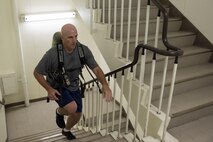 Col. Kenneth Moss, 374th Airlift Wing commander, runs up a flight of stairs during the Sept. 11 Tower Run at Yokota Air Base, Japan, Sept. 8, 2017.
