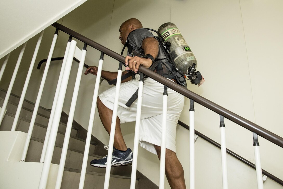 Chief Master Sgt. Elvin Young, 374th Airlift Wing command chief, runs up a flight of stairs during the Sept. 11 Tower Run at Yokota Air Base, Japan, Sept. 8, 2017.