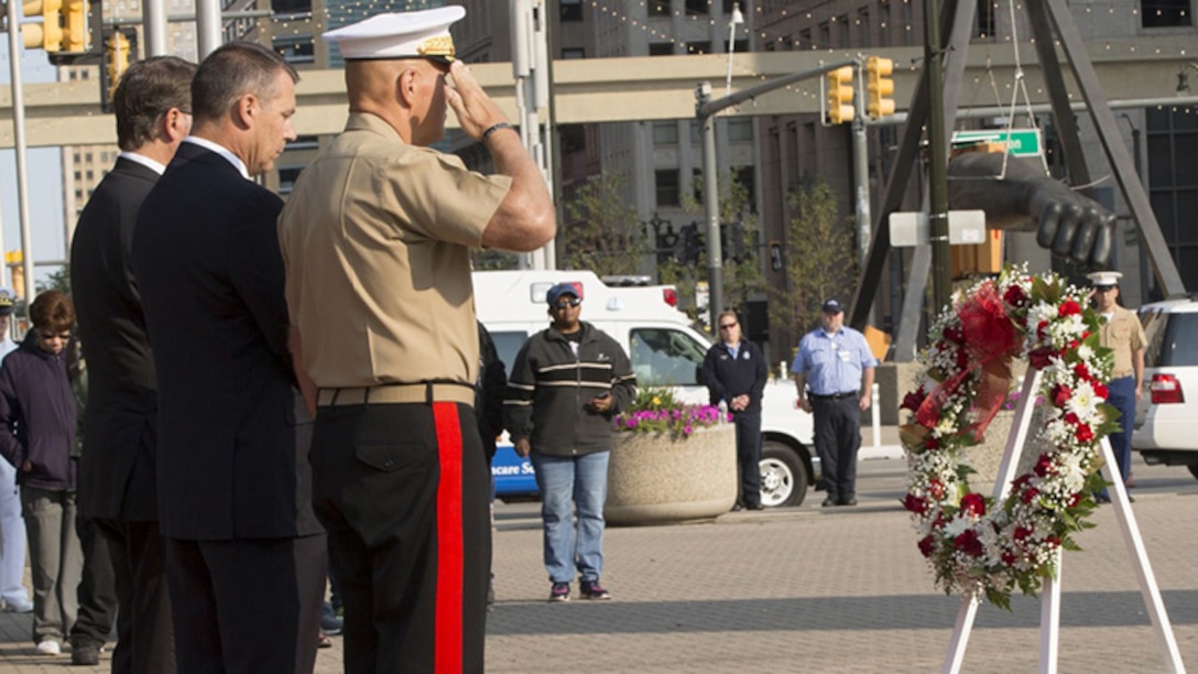 From left, Michigan Sen. Gary Peters, 58, a native of Detroit, John Ellsworth, 45, the father of U.S. Marine Lance Cpl. Justin M. Ellsworth, and Commandant of the Marine Corps Gen. Robert B. Neller honor the wreath of Lance Cpl. Ellsworth at a 9/11 memorial ceremony during Marine Week Detroit, Sept. 10, 2017. Marine Week Detroit is a chance to reconnect with our Marines, sailors, veterans and their families from different generations.