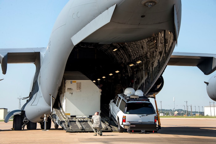 Airmen upload equipment and supplies onto an aircraft.