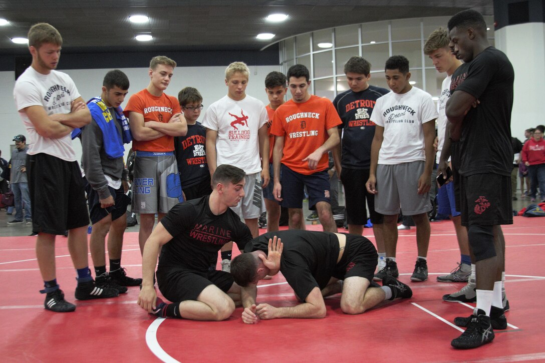 U.S. Marines with the All-Marine Wrestling Team demonstrate different techniques to students of local high schools during the Marine Corps Recruiting Command Wrestling Clinic during Marine Week Detroit Sep. 9, 2017. The Marine Corps Recruiting hosted many events during Marine Week Detroit as a part of their City Partnership Program. MCRC City Partnerships seek to align the Marine Corps with cities that share the essence of Marines - an irreducible fighting spirit. Some events hosted included High School visits supported by the Silent Drill Platoon, a Community Leaders Reception, a photography competition showcasing Detroit's fighting spirit, youth basketball and wrestling clinics, three on three basketball tournament, a cooking competition featuring an Expeditionary Field Kitchen, and more. MCRC leveraged existing partnerships with USA Wrestling, Women's Basketball Coaches Association and local contacts in the city to create events in celebration of the emerging partnership. Other City Partnerships in development include Baltimore, New Orleans, Chicago, Dallas, and Oakland, California. (U.S. Marine Corps photo by Sgt. Nathan Wicks)